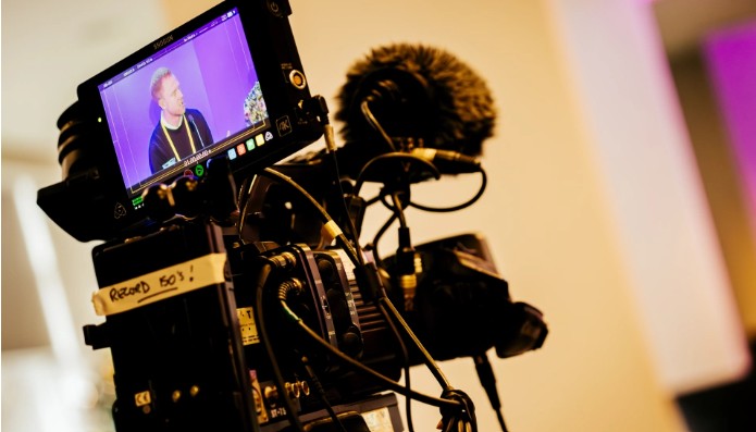 Camera and microphone featuring an image of National Energy Action's conference